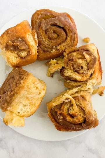 Gluten free cinnamon rolls on a white plate.