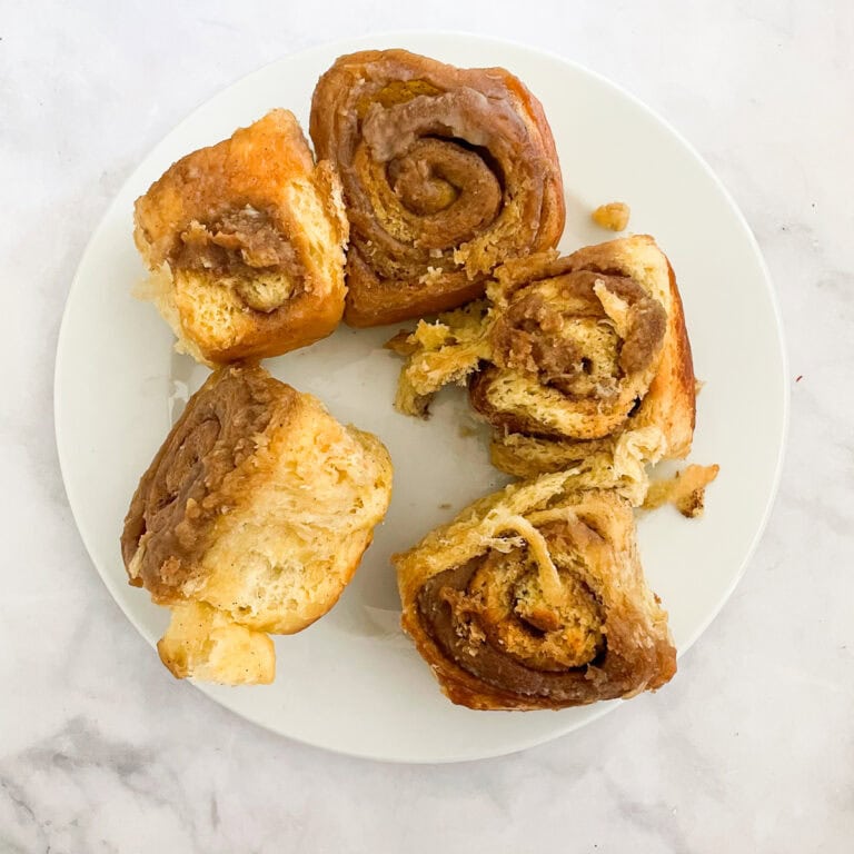 Gluten free cinnamon rolls on a white plate.