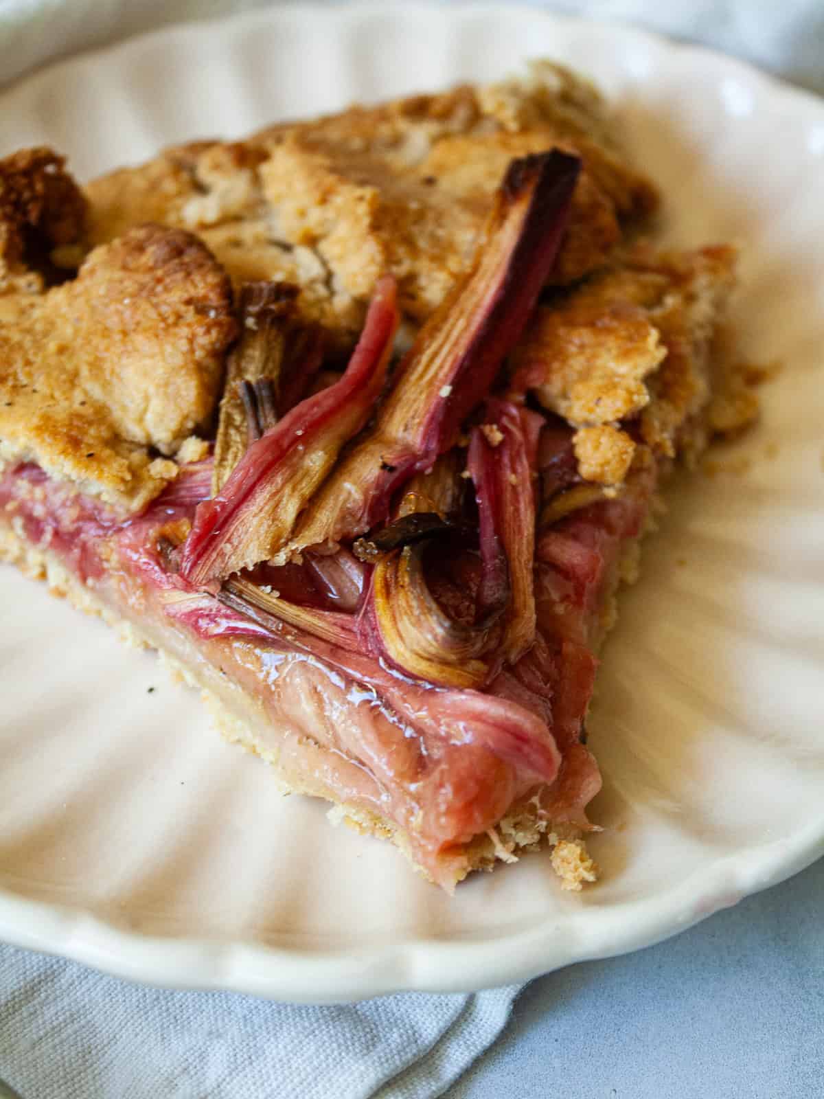 A close up of a slice of rhubarb galette on a plate.