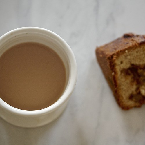 A slice of whole grain apple cake and a cup of coffee.