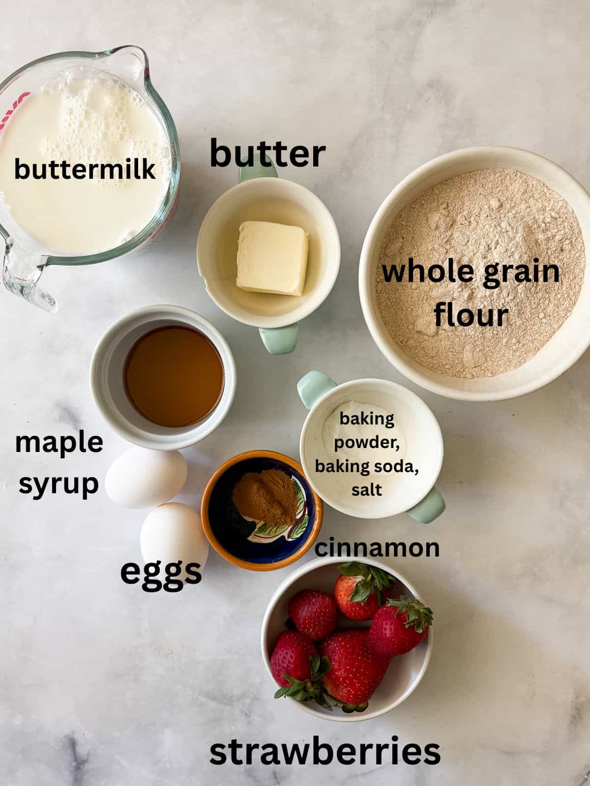 These strawberry pancakes feature fresh, juicy strawberries, whole grain flour, and a light and fluffy crumb. Gluten-free if needed. Ingredients for strawberry pancakes are text-labeled.