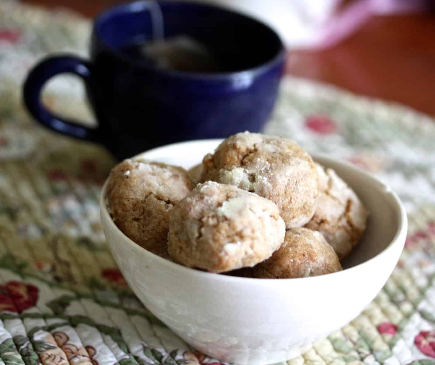A bowl of cookies and tea.