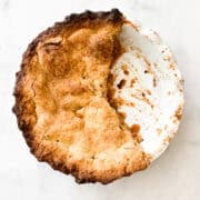 Half of a Gravenstein apple pie in a pie pan.