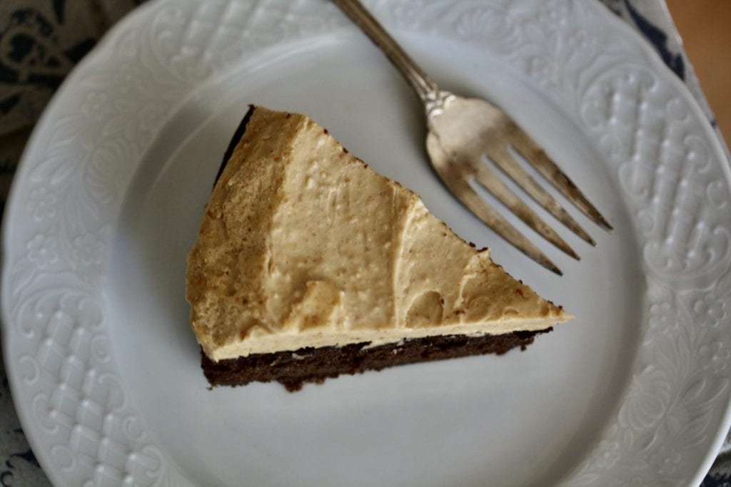 A slice of peanut butter chocolate cake on a plate.