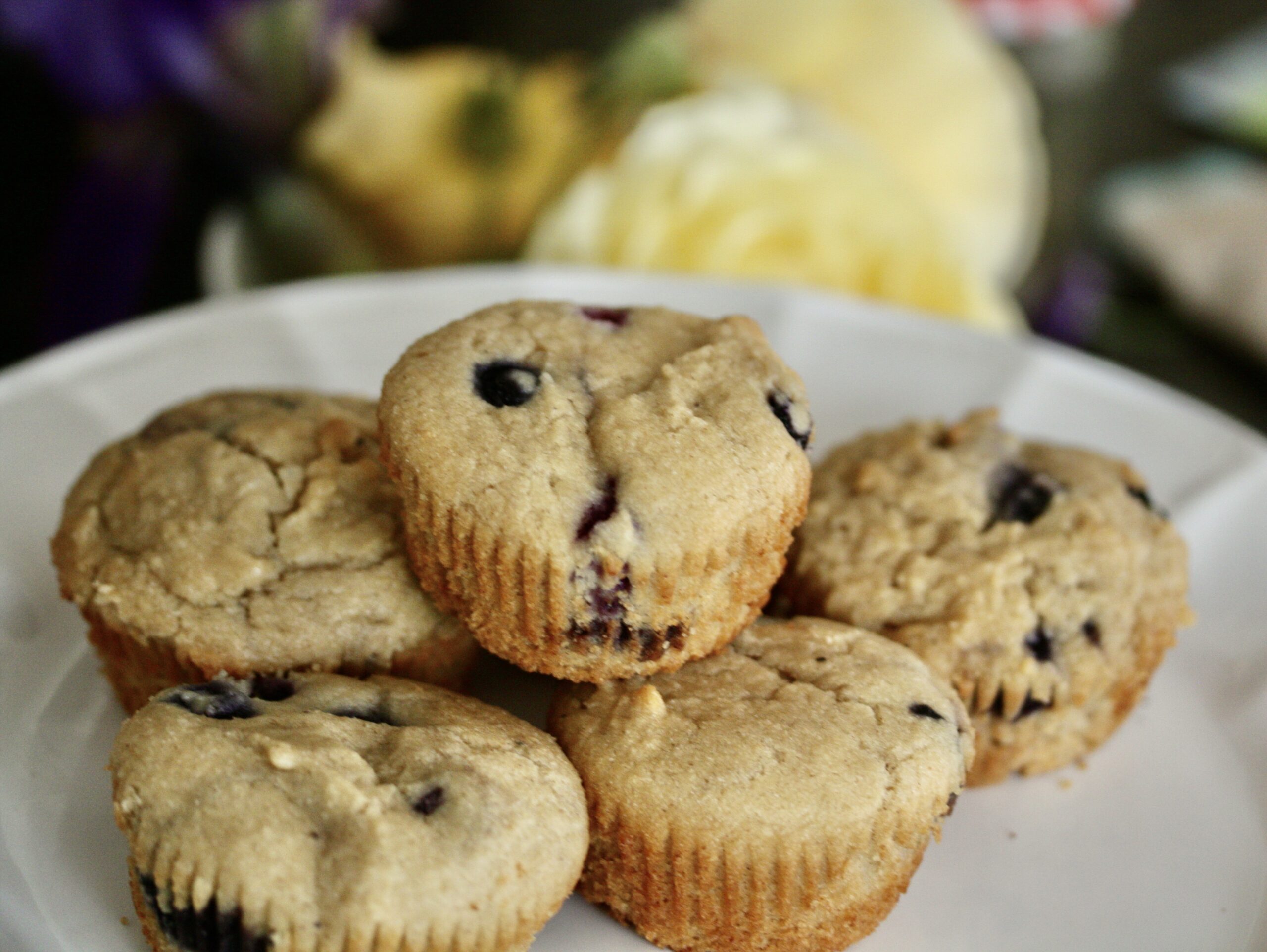 A plate of gluten-free blueberry muffins.