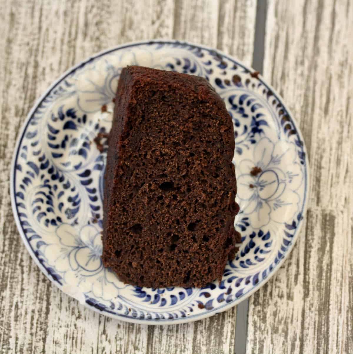 A slice of gluten-free chocolate zucchini cake on a plate.