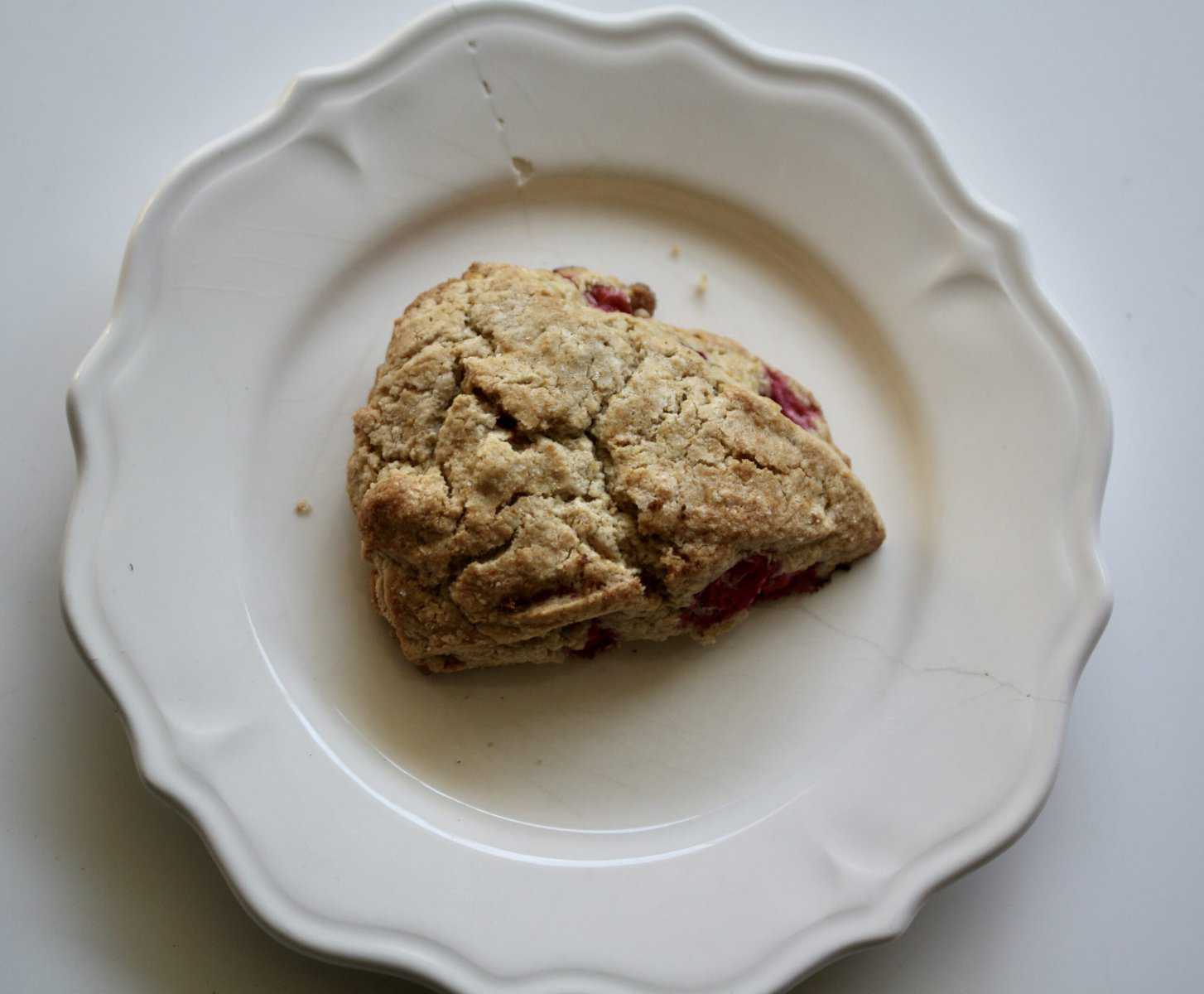 A cranberry scone on a plate.