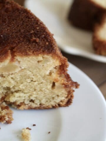 Gluten-free pear cake with a plate of cake in the background.