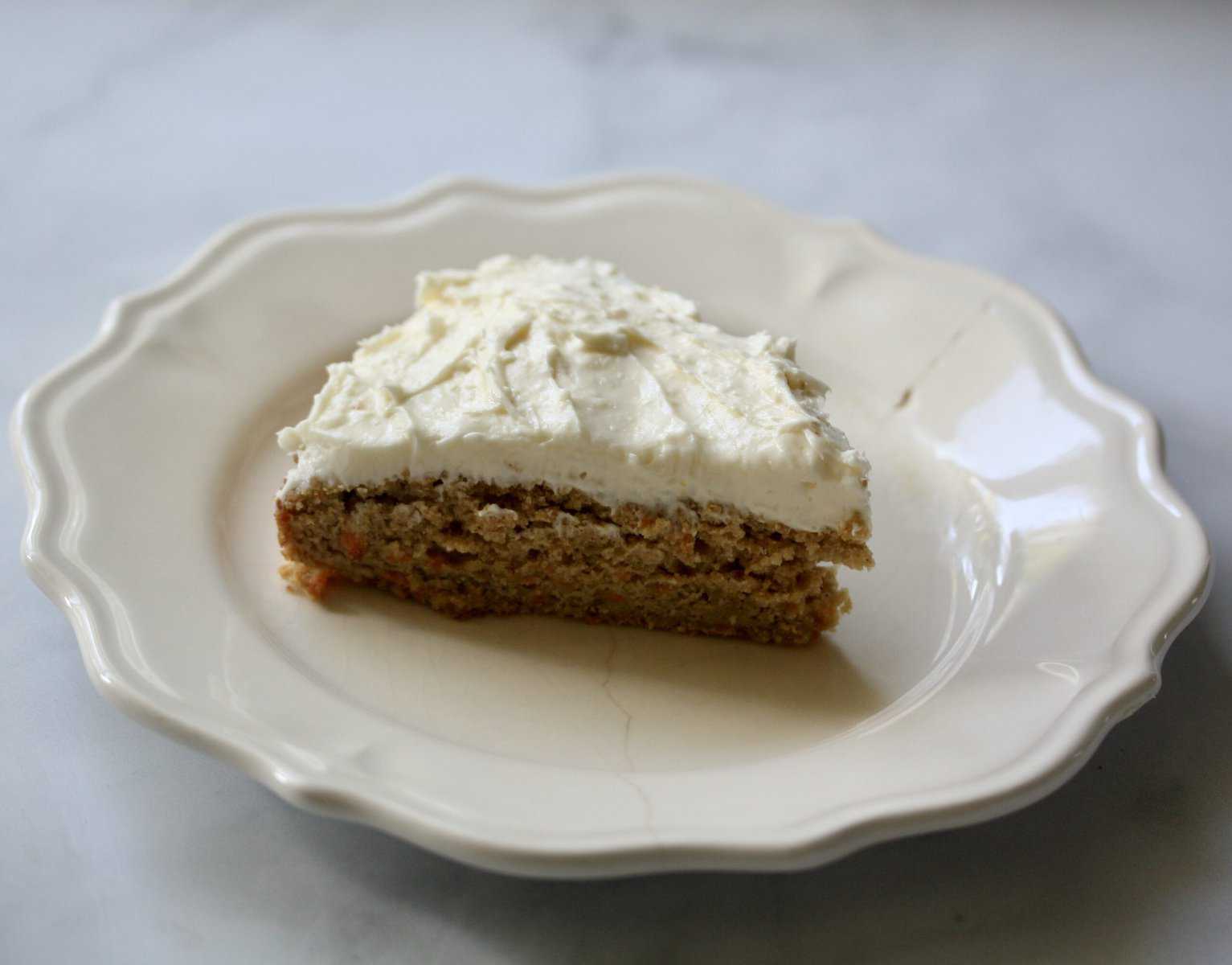 A slice of gluten-free carrot cake on a plate.