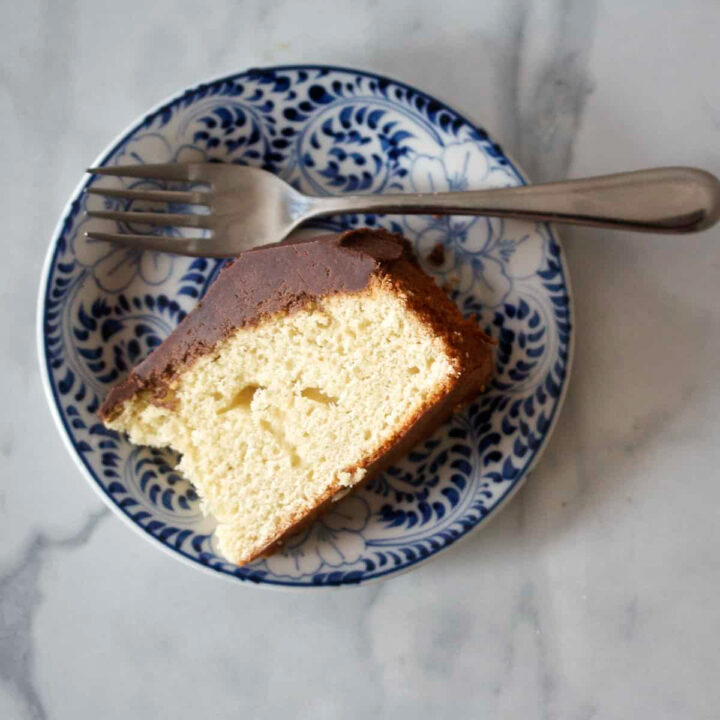A piece of butter cake on a blue and white cake.