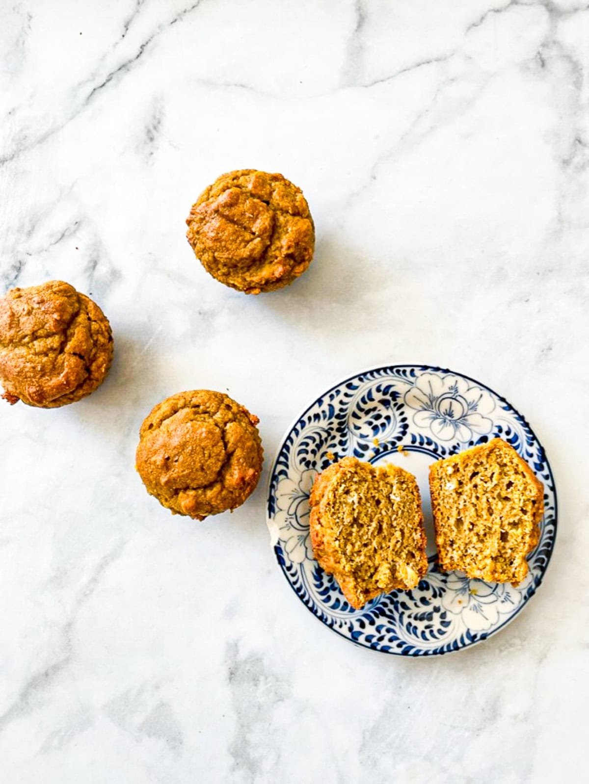 Gluten free pumpkin muffins on a white background.