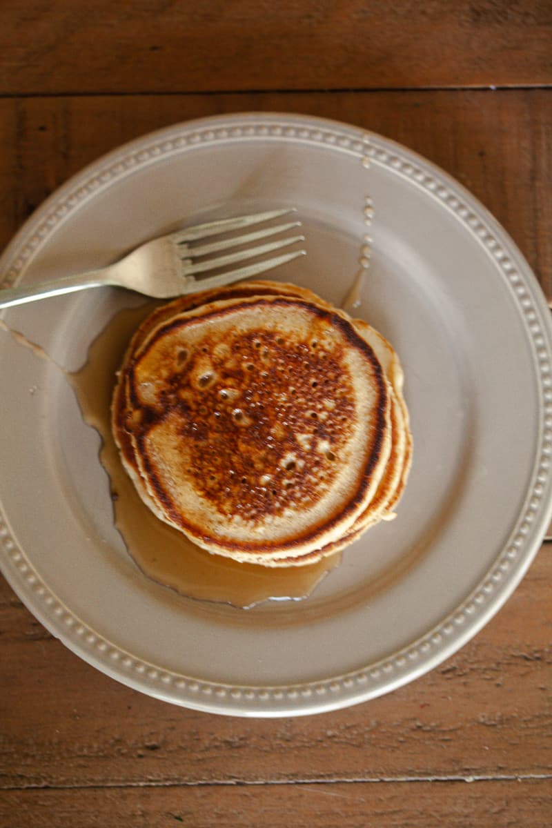 Oat flour pancakes on a plate with a fork.