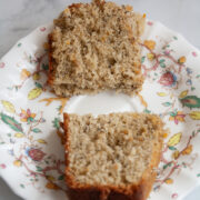 Two halves of a slice of earl grey cake on a plate.
