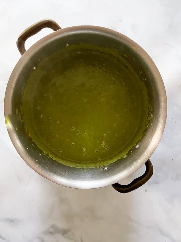 Vegan asparagus soup in a pot after being pureed.