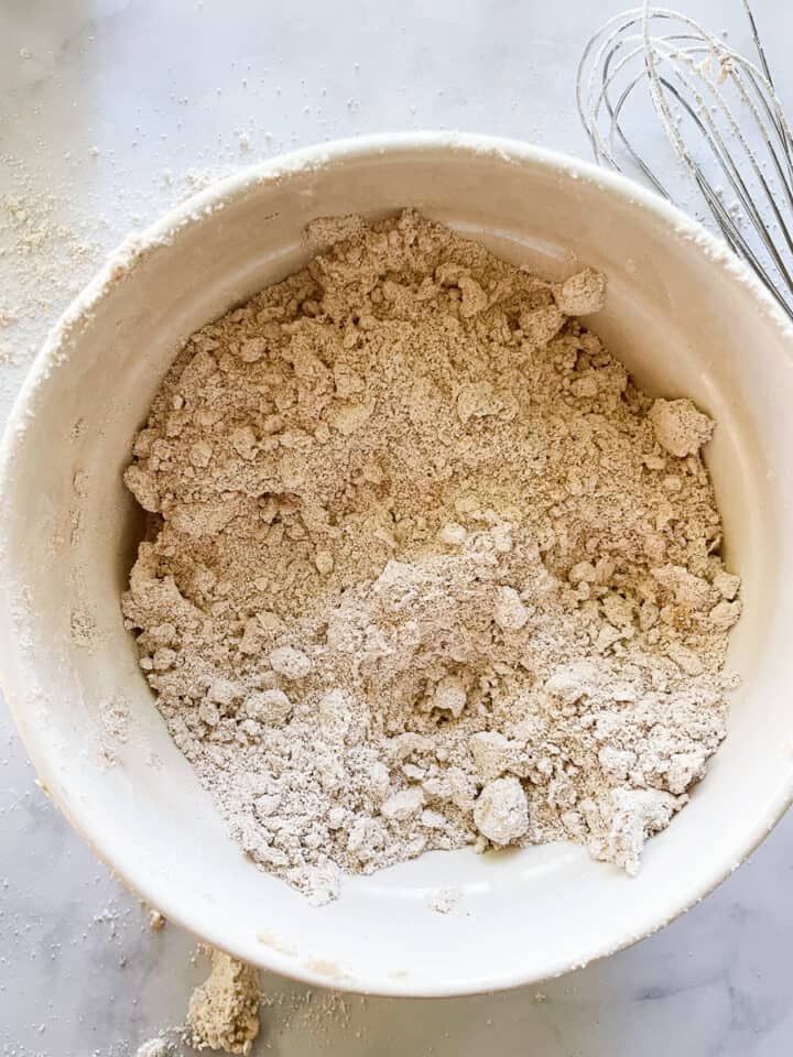 Butter is rubbed into the flour mixture.