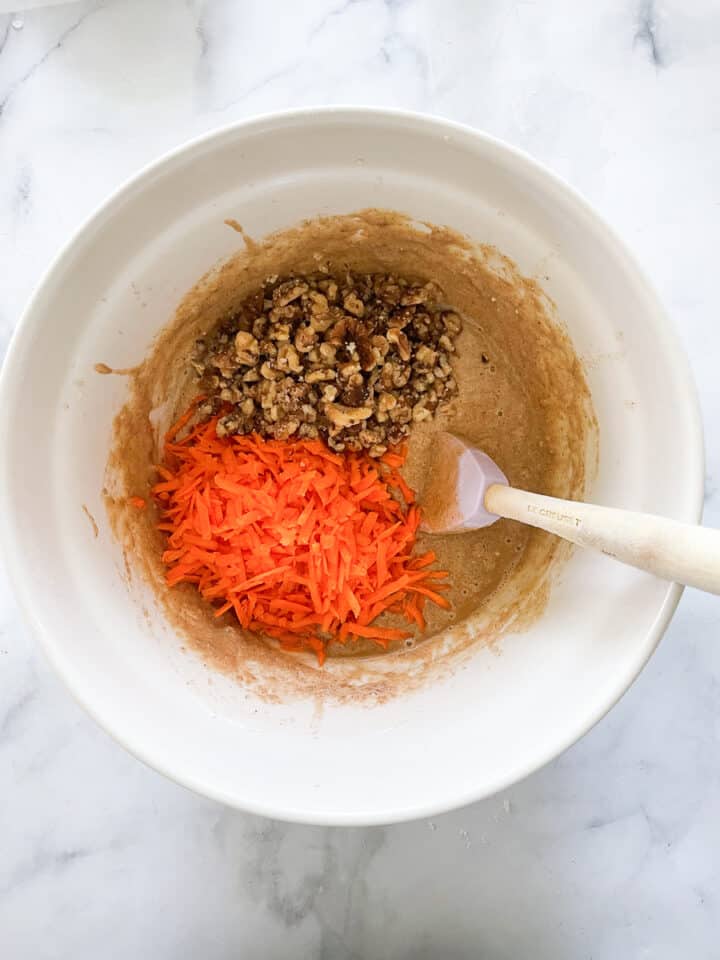 Shredded carrots and walnuts are added to the batter.