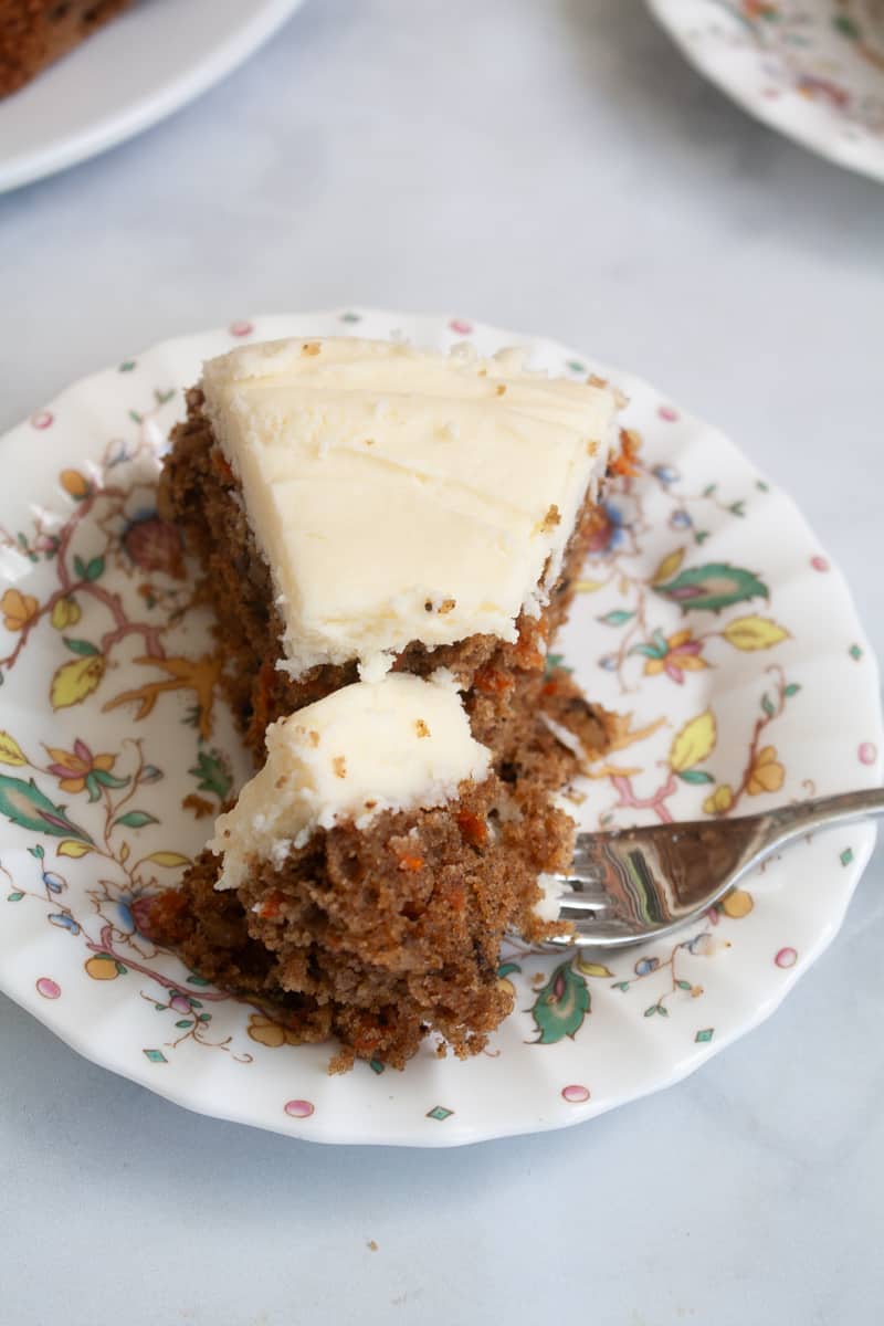 A fork cuts into a piece of gluten free carrot cake.
