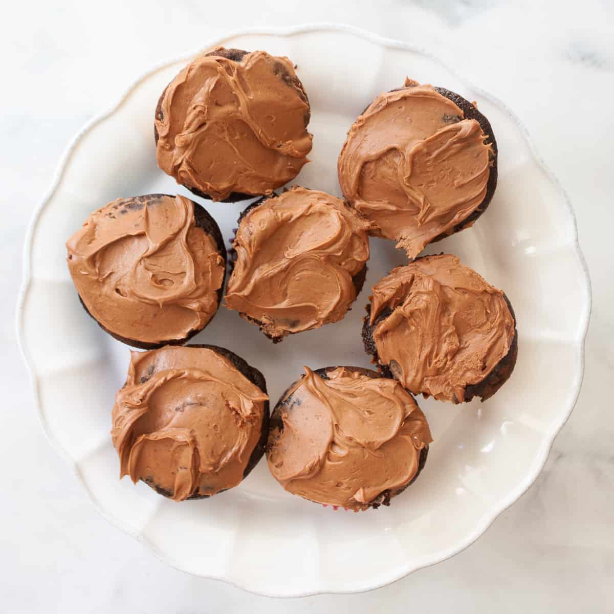 Gluten free chocolate cupcakes are arranged on a serving stand.