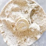 A close up of oat flour in a food processor.