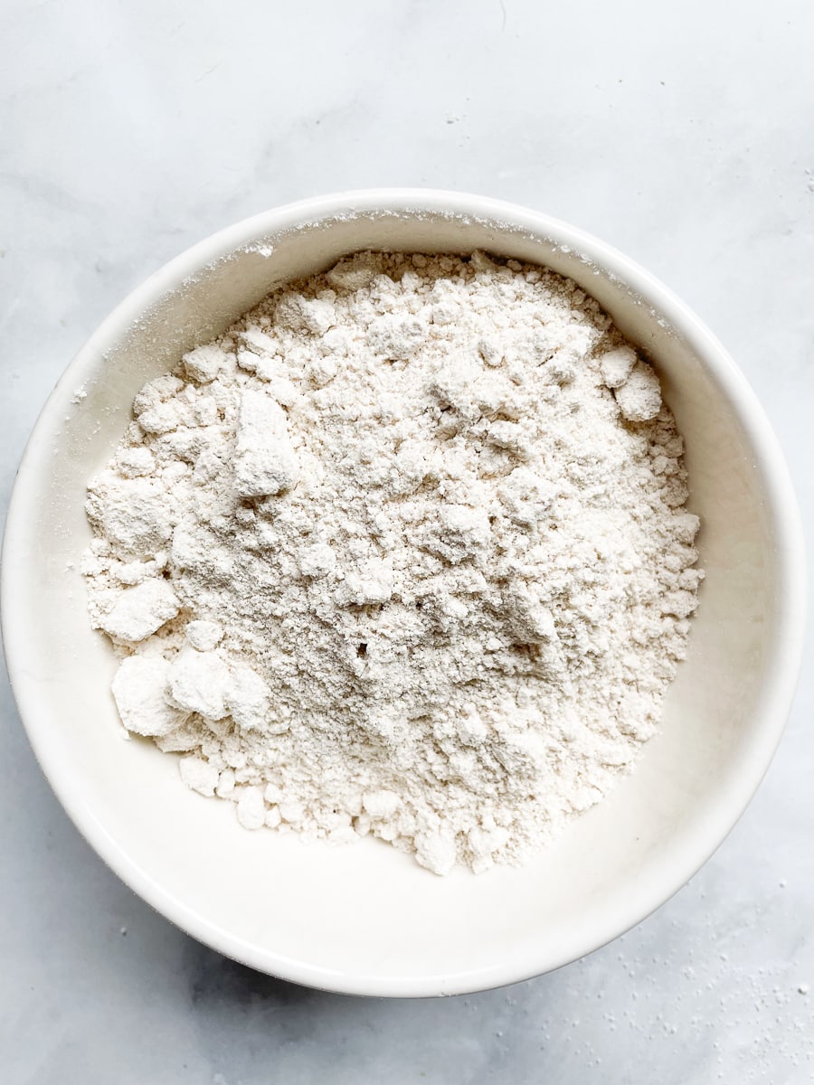 A white bowl of gluten free flour blend.