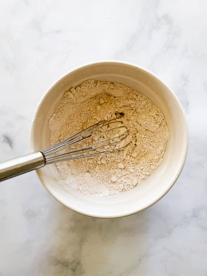 The dry ingredients are whisked in a bowl.