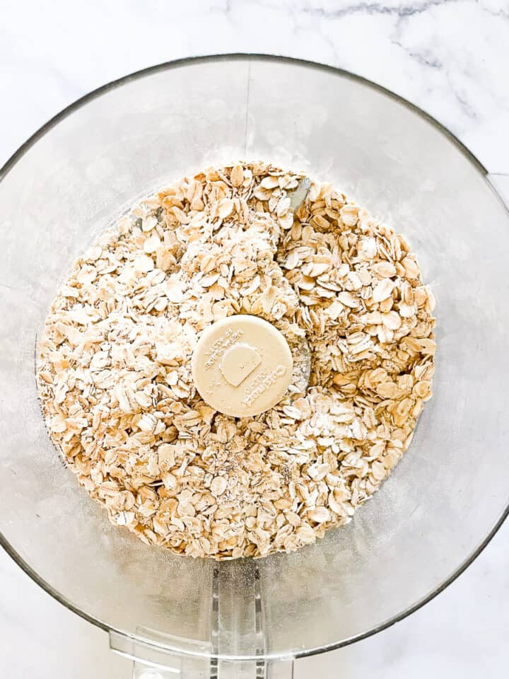 Oats are placed in a food processor.