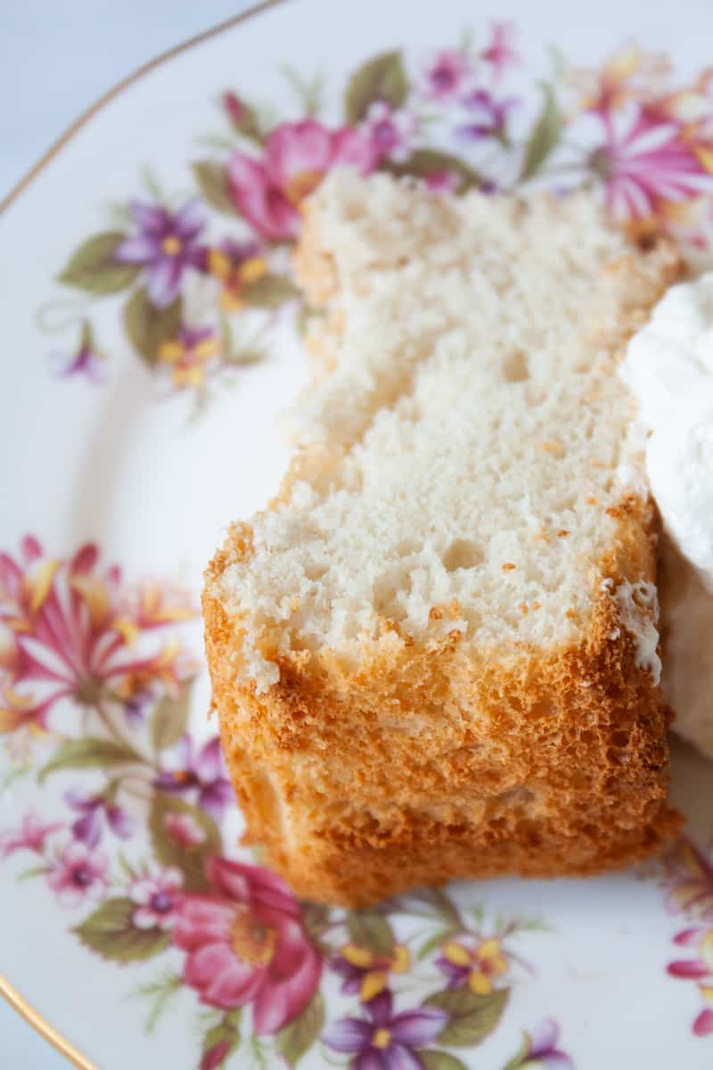 A close up of a slice of angel food cake on a plate.