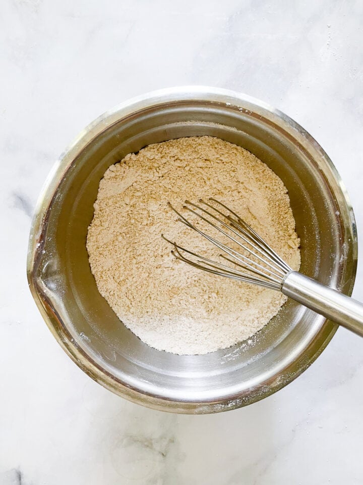 Arrowroot and sugar are whisked together in a bowl.