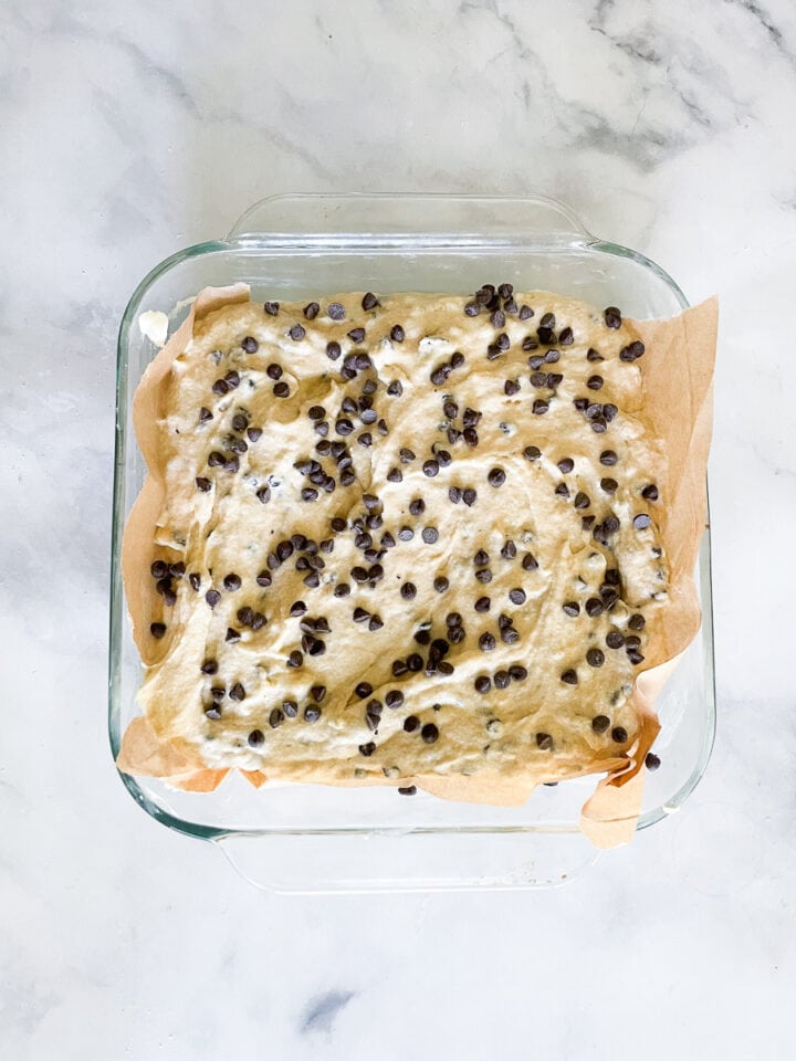 The cake batter topped with chocolate chips in the pan.