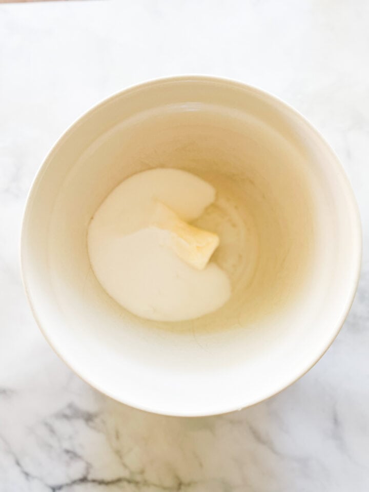 Butter and sugar are added to a bowl.