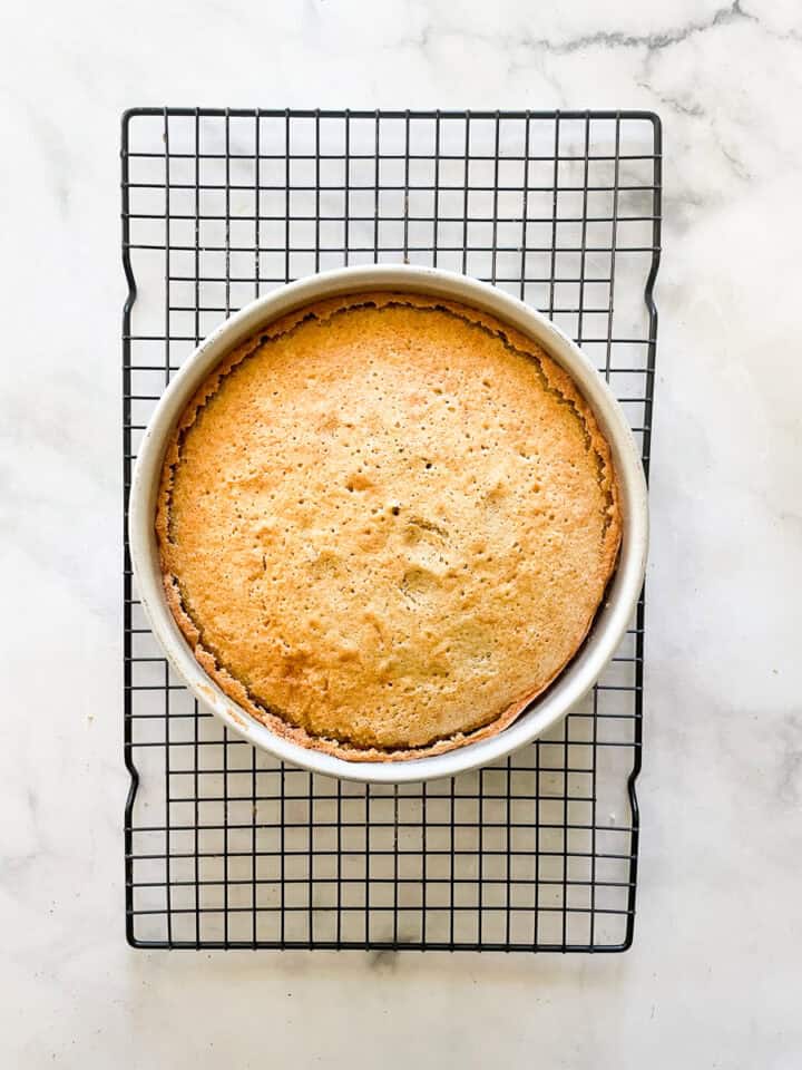The gluten free butter cake cools in the pan on a rack.