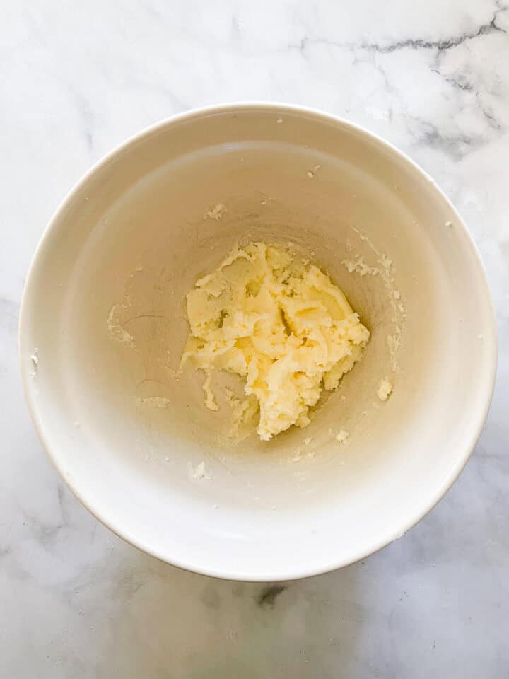 Butter and sugar creamed in a bowl.