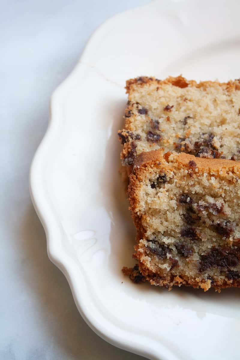 Two slices of gluten free chocolate chip loaf cake on a plate.