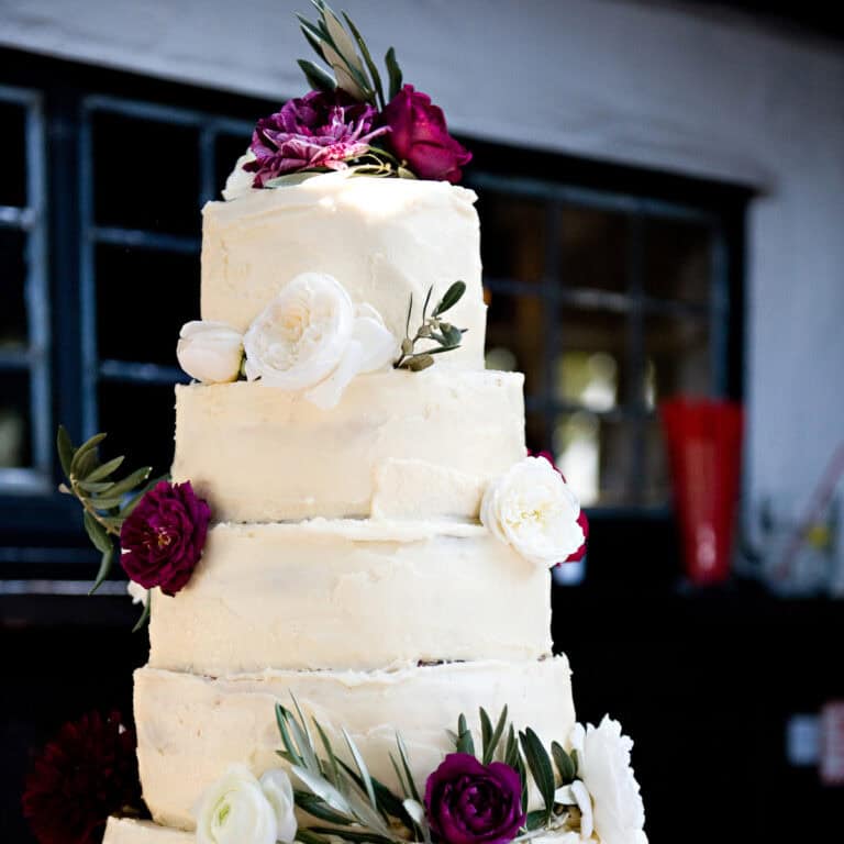 A homemade wedding cake decorated with flowers.