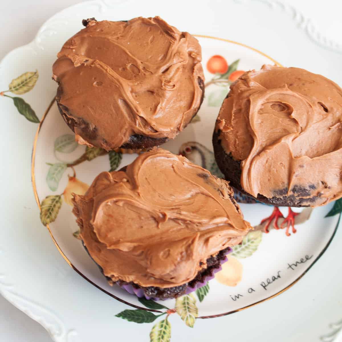 Three oat flour chocolate cupcakes on a plate.