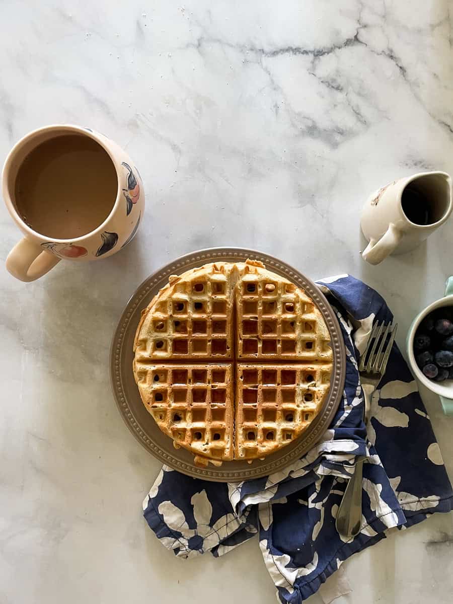 Maple syrup is drizzled on top of gluten free waffles for two.