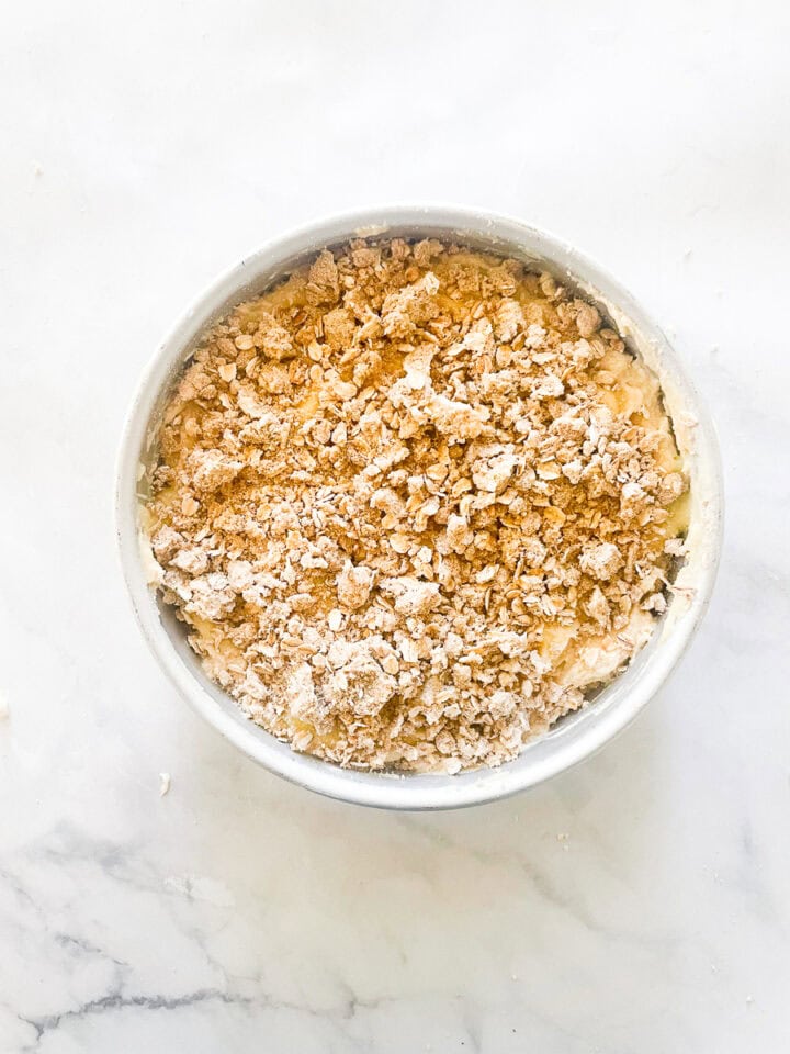 The cake batter is topped with lemon curd and crumb topping.