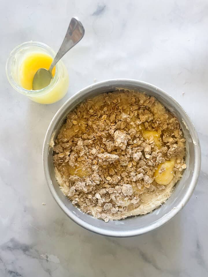 Lemon curd and crumb topping are dolloped on top the batter.