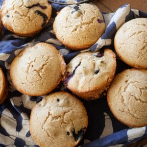 A pile of oat flour blueberry muffins.