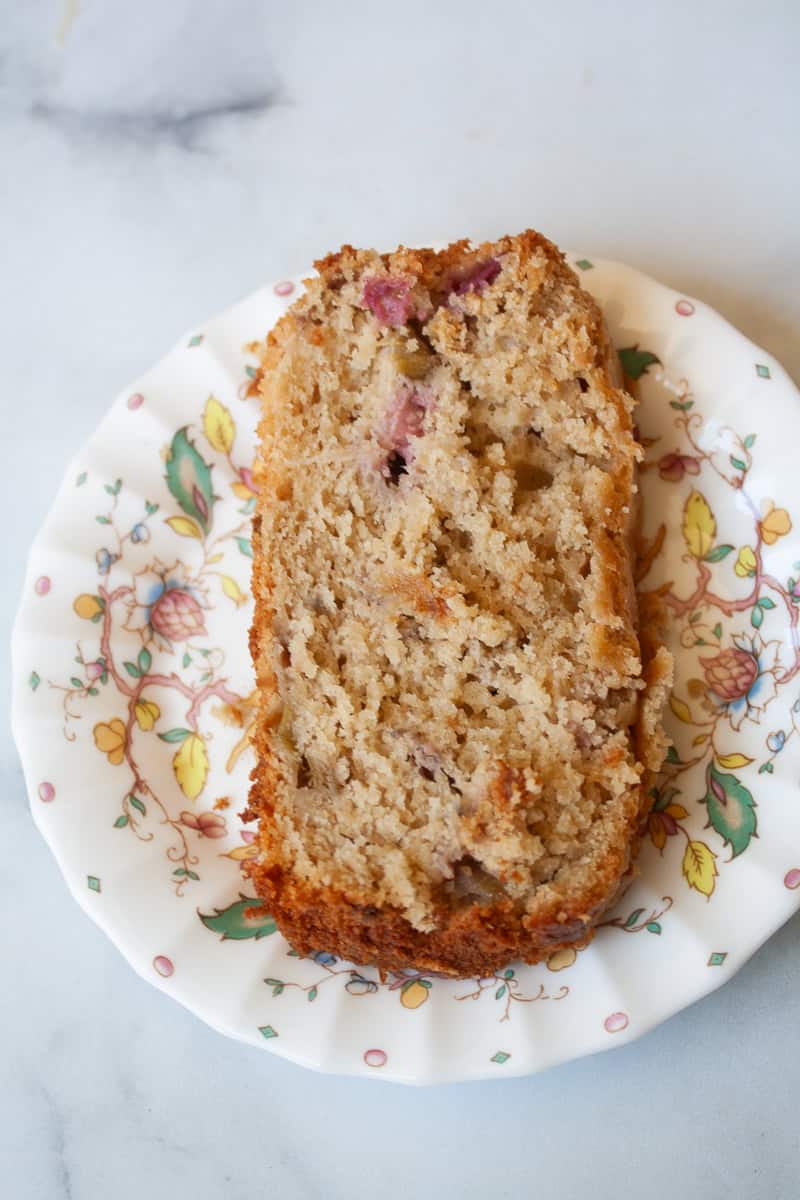 A slice of gluten free rhubarb bread on a flowered plate.