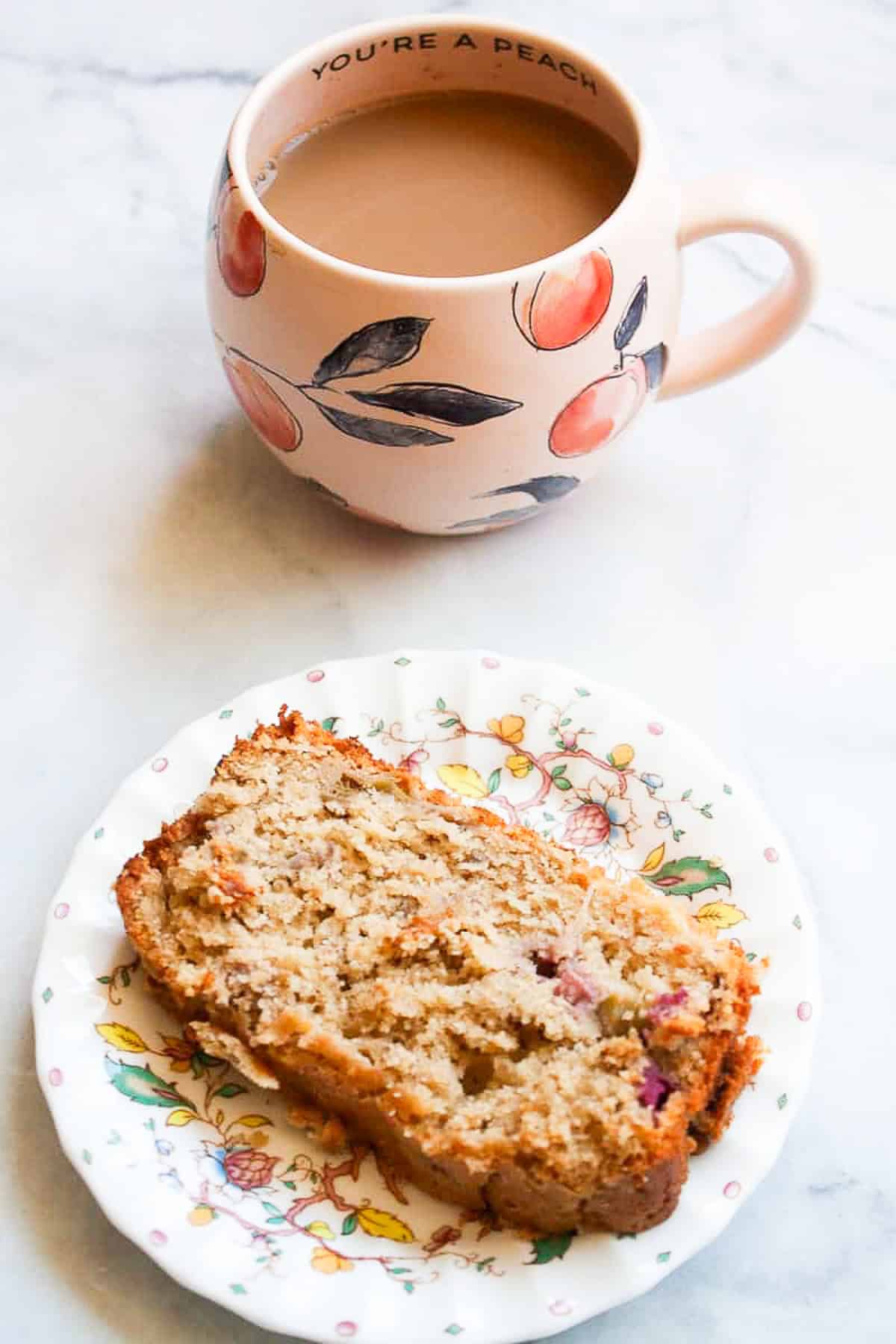 A slice of gluten free rhubarb bread and a cup of coffee.