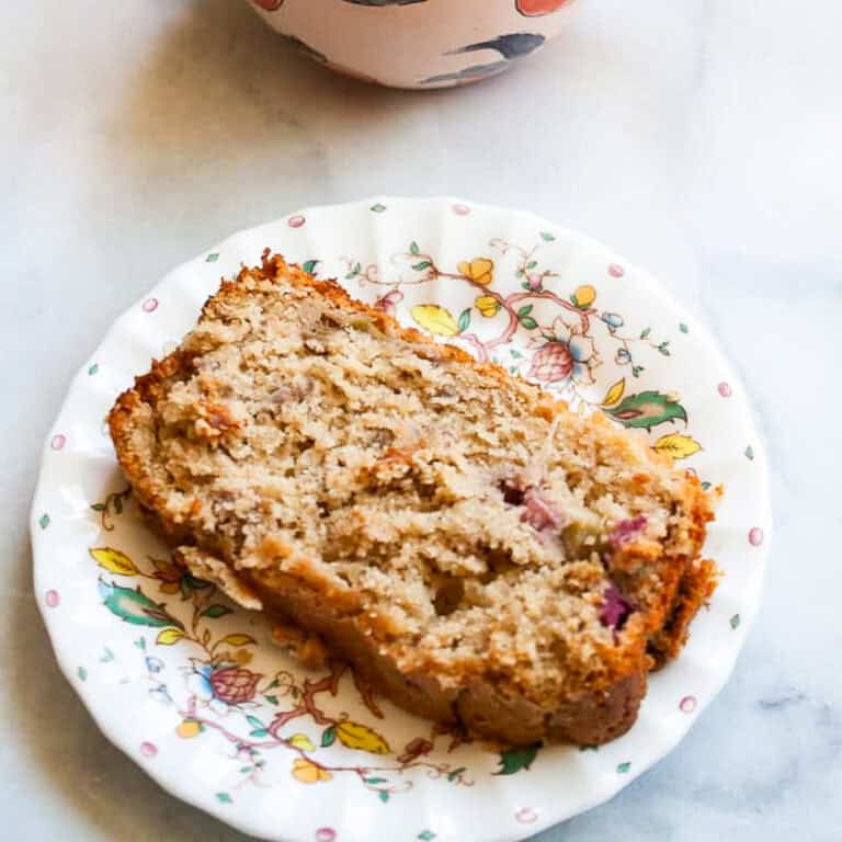 A slice of gluten free rhubarb bread and a cup of coffee.