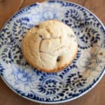 A gluten free banana blueberry muffin on a plate.