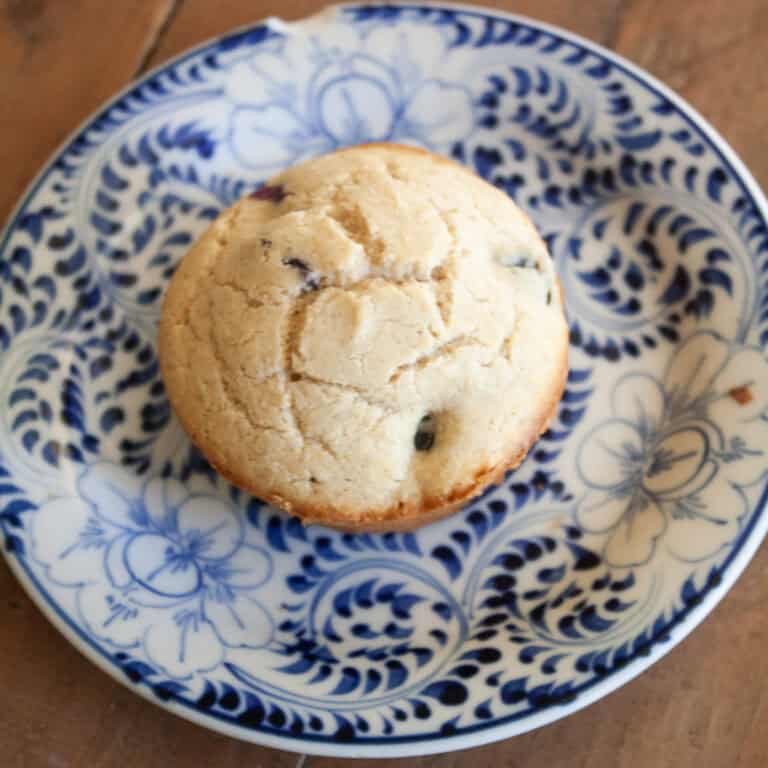 A gluten free banana blueberry muffin on a plate.