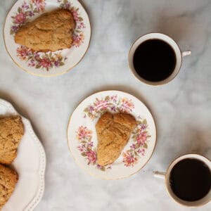 Rhubarb scones on plates with little cups of black coffee.