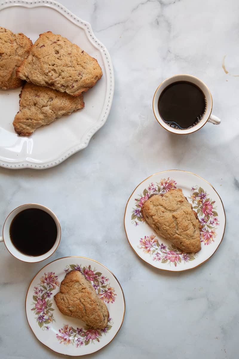 Cups of coffee and plates of gluten free rhubarb scones.