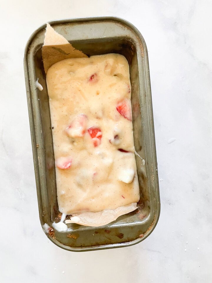 Strawberry rhubarb bread batter in a loaf tin.