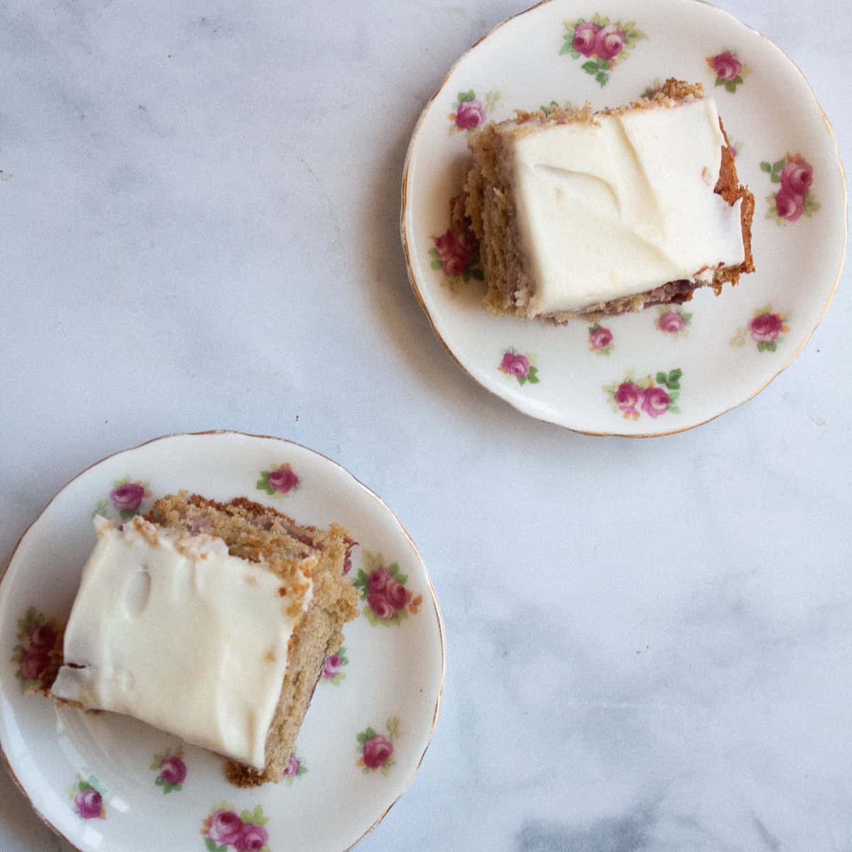 Two pieces of gluten free strawberry buttermilk cake on small plates.