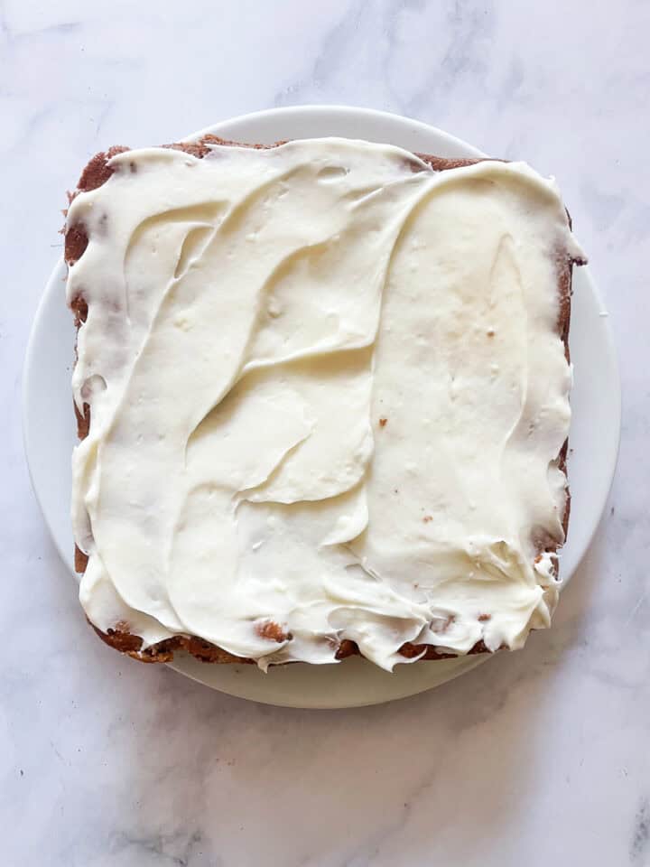 Cream cheese icing is added to the strawberry buttermilk cake.