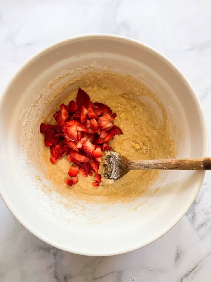 Strawberries are added to the muffin batter.